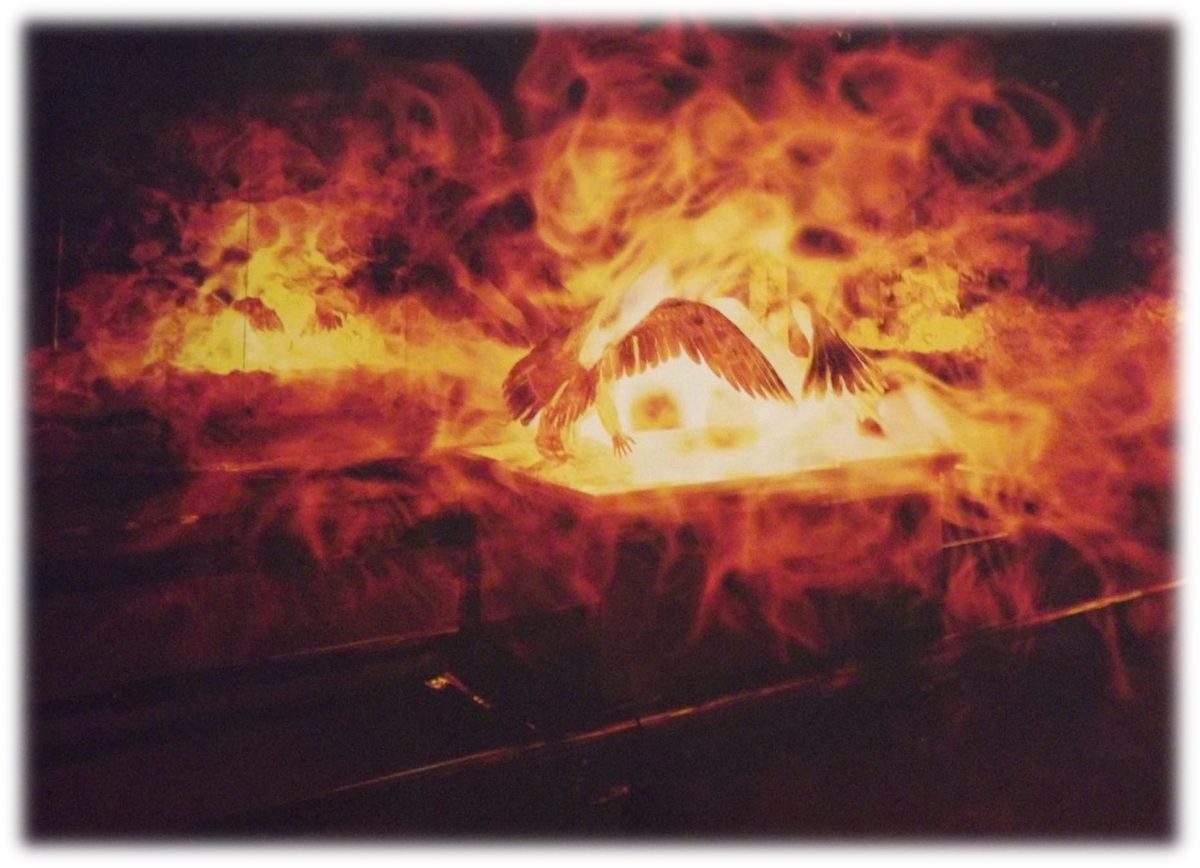 The Mercy Seat with its two cherubim, wings outstretched, wrapped in flames that fill the whole picture