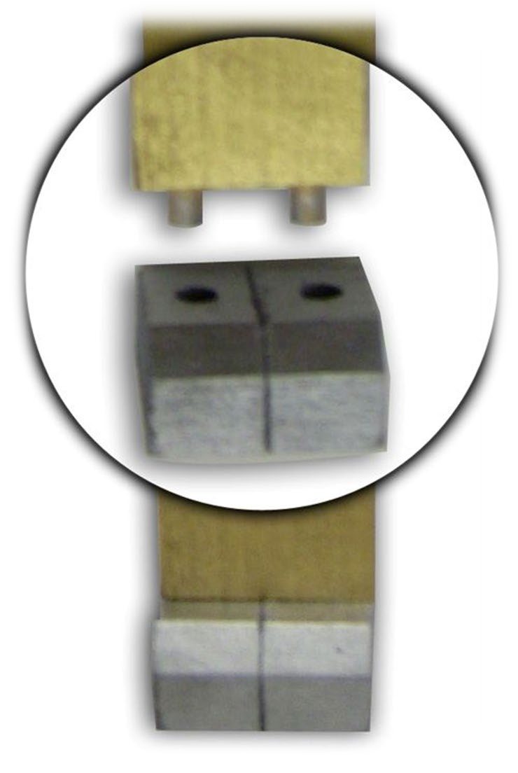 Close view of the foot of a gold-covered board with its two tenons above a pair of silver sockets, and the board seated in the sockets