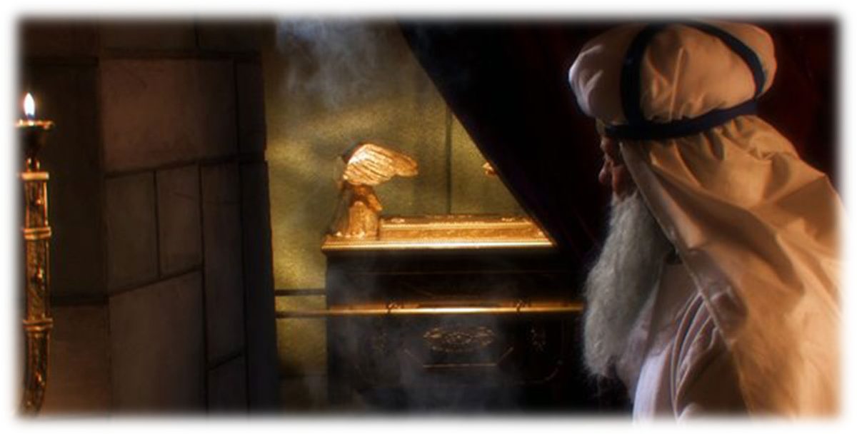The high priest in white linen and turban standing within the veil before the Ark of the Covenant, the cloud of incense drifting over the Mercy Seat