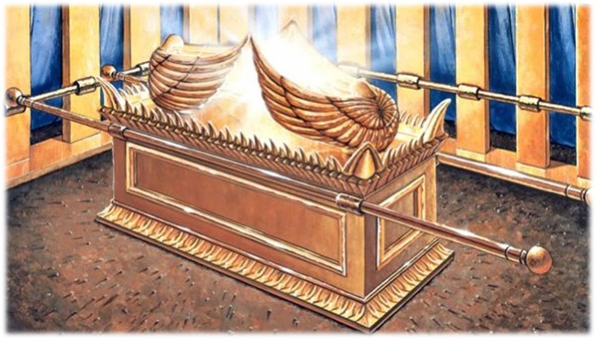 The gold Ark standing before the blue and white curtains of the Tabernacle, with a decorated gold crown running round the top of the chest and the staves in their rings